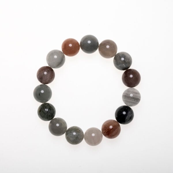 Healing crystal bracelet made of multi-color rutilated quartz beads arranged in earthy tones for grounding and clarity
