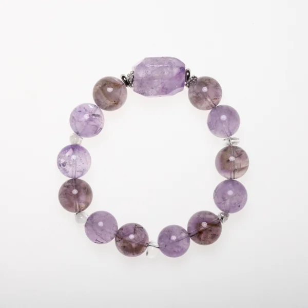 Amethyst crystal bracelet with lavender tones and faceted centerpiece, designed for calm, clarity, and emotional healing.
