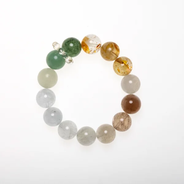 Forest Tempo healing crystal bracelet laid flat in a circular arrangement, showing all seven gemstone colors.