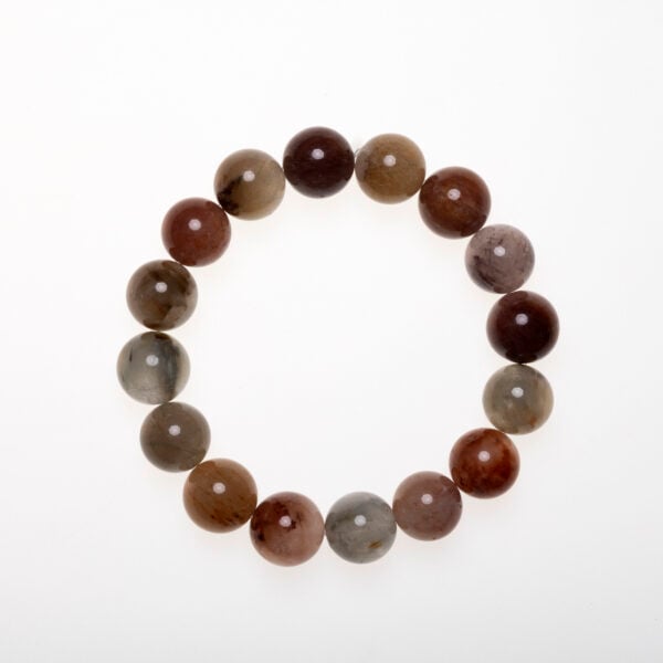 Natural red rutilated quartz bracelet arranged on clean flatlay